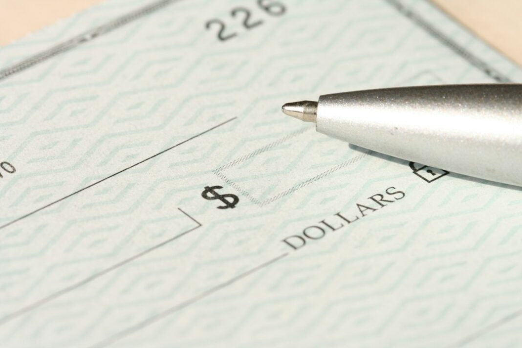 Private-Sector Compensation Cost Employers $46.89 an Hour in June Representative check and pen image for employer compensation-cost coverage. Photo by Money Knack on Unsplash.