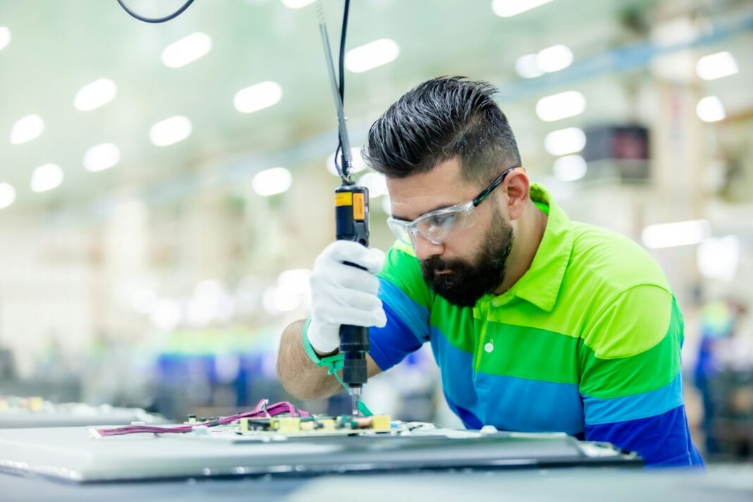 Representative factory technician image for semiconductor workforce training coverage. Photo by Alireza Hatami on Unsplash.
