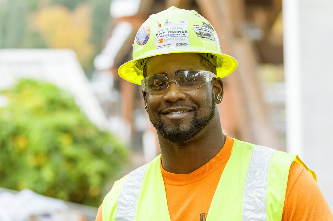 Apprenticeship Is Growing. Completion Is the Harder Test for New-Collar Training Carpenter apprentice Jory Robertson in a hard hat and safety vest on a construction site