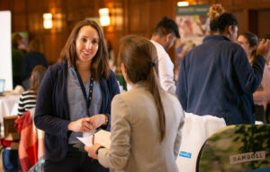 Students speak with employer representatives at a University of Michigan career fair