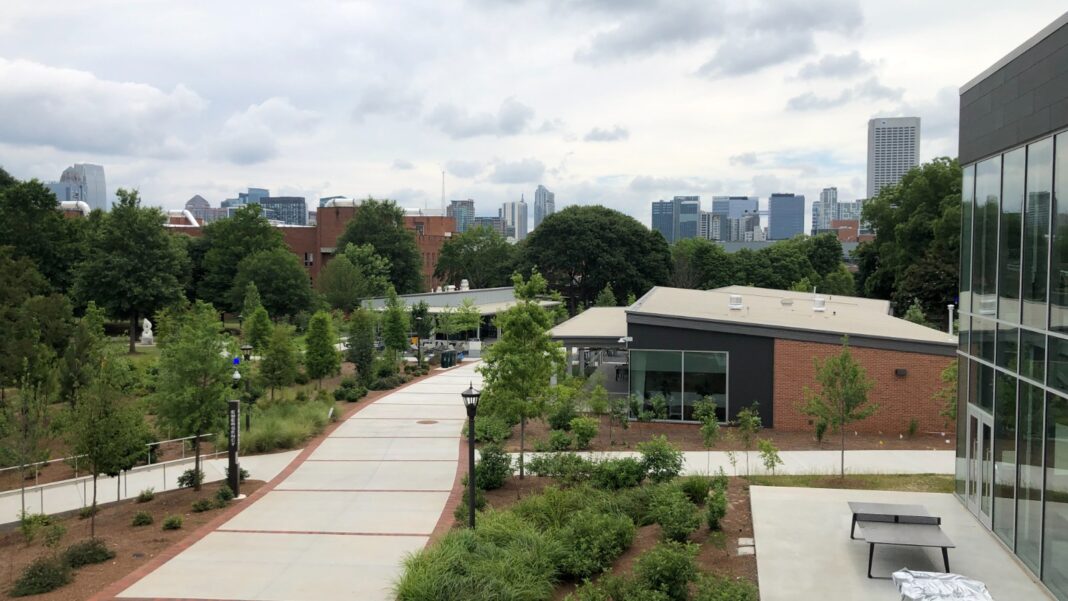 Georgia Tech’s September 28 AI Career Fair Targets a Specific Talent Market A landscaped walkway outside Georgia Tech's Exhibition Hall with the Midtown Atlanta skyline in the distance