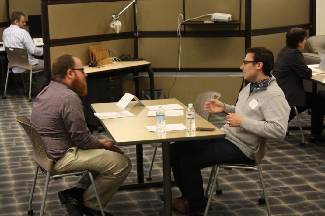 Is Hiring Now a Screening Problem? National Data Can’t Say, but Employer Funnels Can Recruiters interview candidates at tables during an employer matchmaking session at Tech Elevator