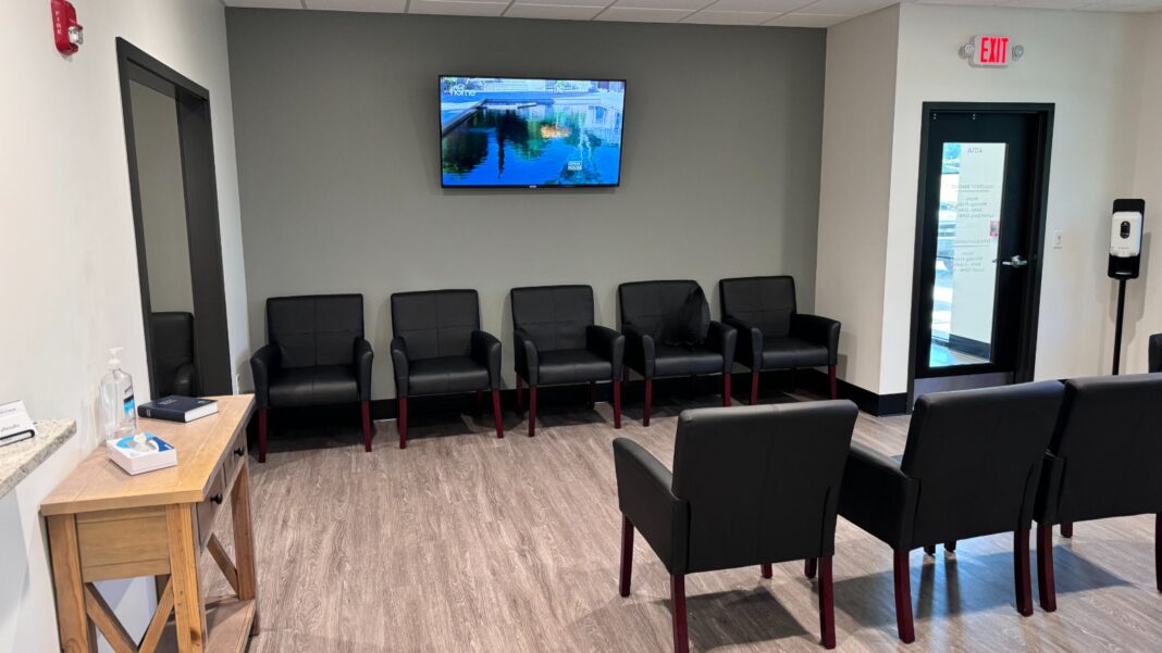 Lower-Wage Workers With Family Health Coverage Pay a Larger Share of Premiums An empty clinic waiting room with black armchairs along the walls, a small desk and a wall-mounted television