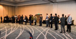 Job seekers stand in a long line at an Air Force Civilian Service hiring fair in a hotel ballroom