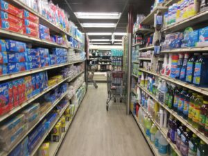 A grocery store aisle stocked with packaged goods and price labels in New Orleans