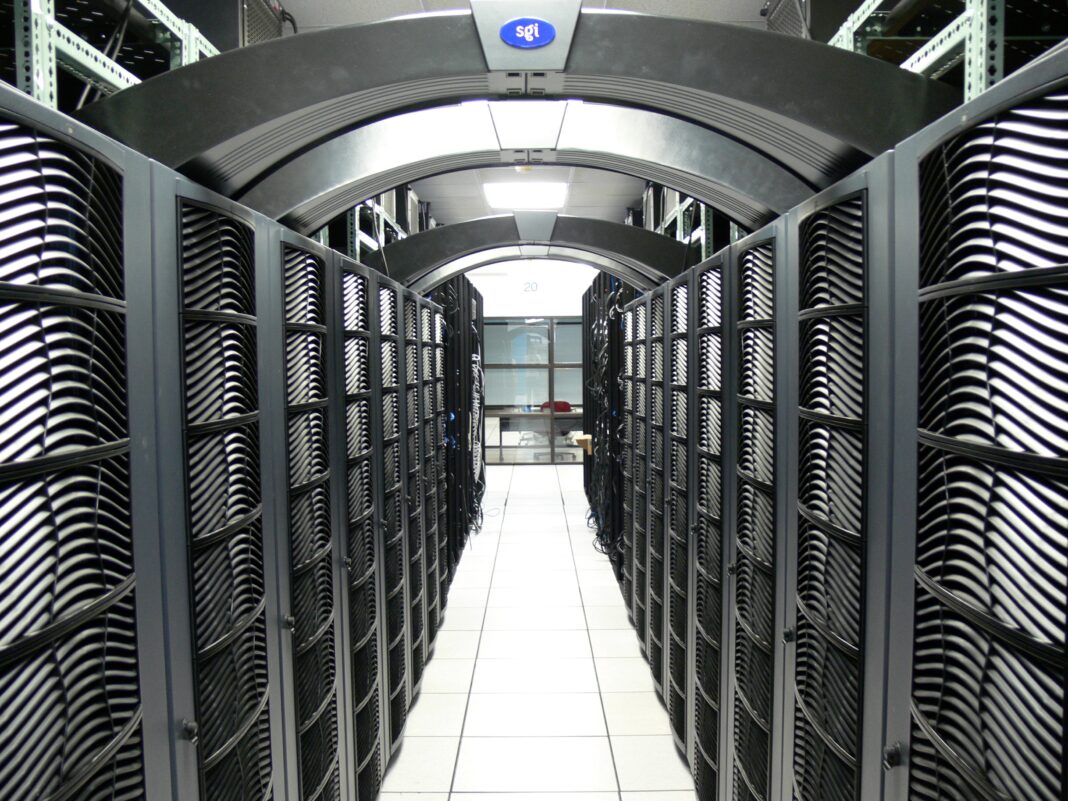 A long aisle between rows of server racks in the Virginia Tech data center