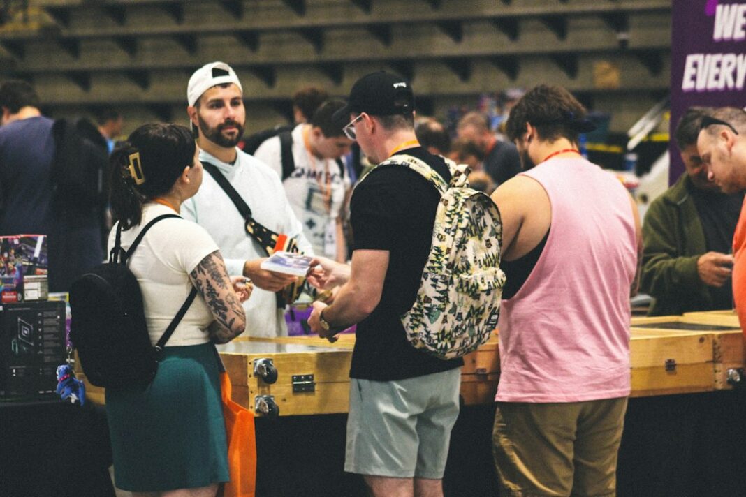 People gathered at an indoor event booth, used as a representative image for a career fair.