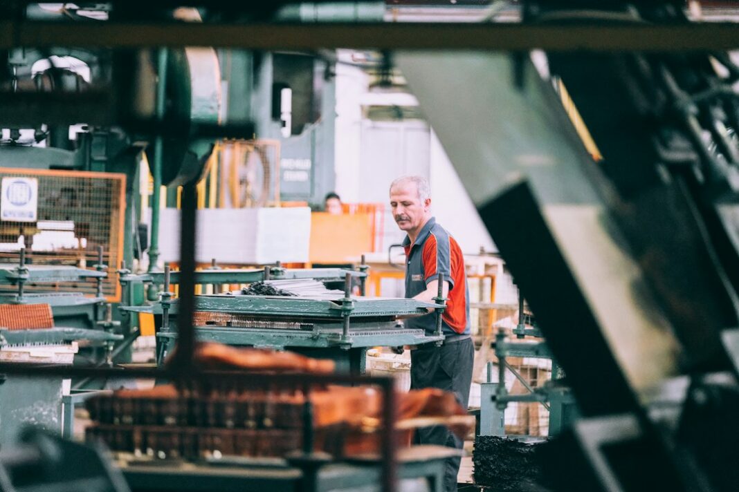 An industrial worker operating machinery, used as a representative image for advanced manufacturing.