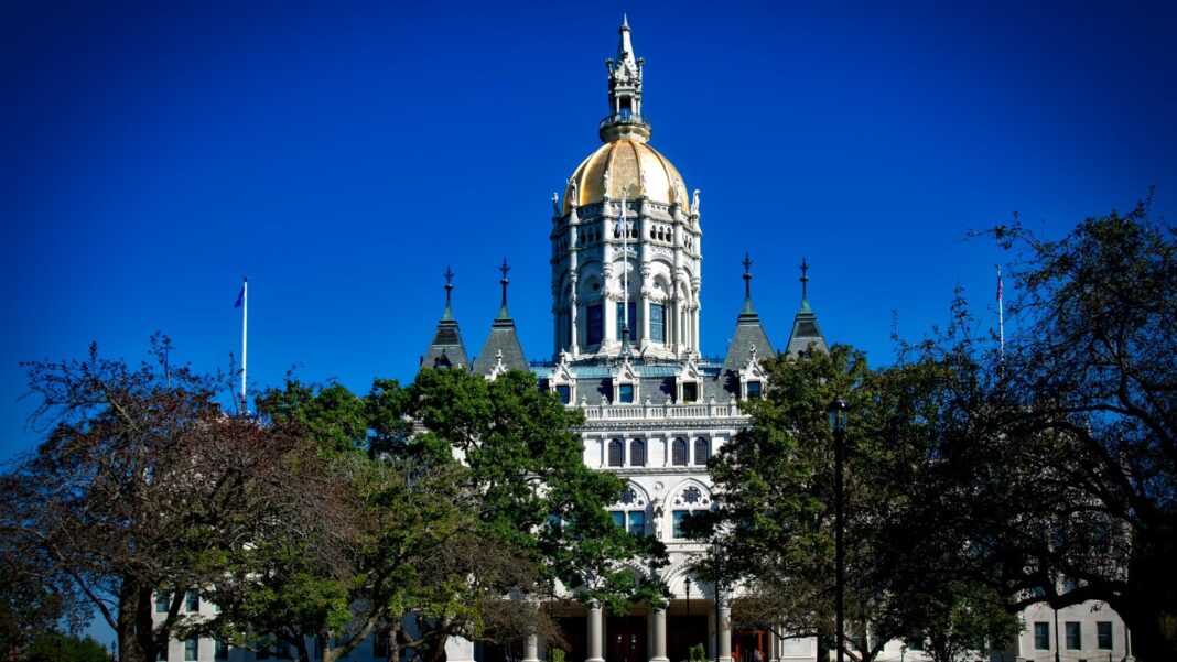 Connecticut Job Postings Must Include Pay Ranges and Benefits Starting October 1 The gold-domed Connecticut State Capitol rises above green trees against a deep blue sky