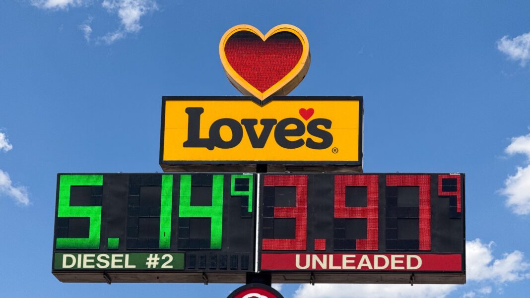 Truck stop price sign with a red heart logo showing diesel at 5.14 9/10 dollars in green digits and unleaded at 3.93 9/10 in red digits