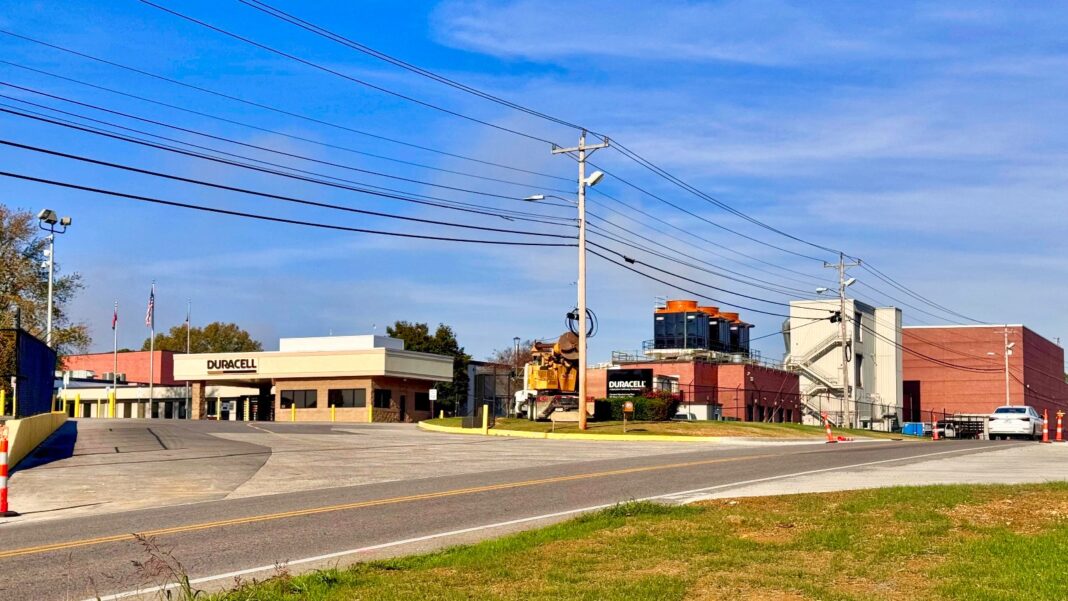 Duracell Opens $56 Million Atlanta R&D Center Expected to Create 120 Jobs Street view of a low brick and tan industrial building with a Duracell sign, power lines and a road in the foreground