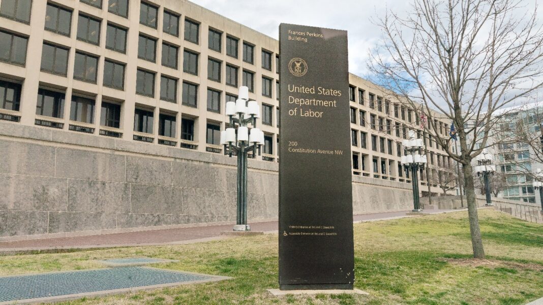 Labor Department Drops Plan to Pull Decades-Old Overtime and Coverage Guidance From Federal Rules A long concrete office building with rows of square windows behind a dark United States Department of Labor sign on a lawn