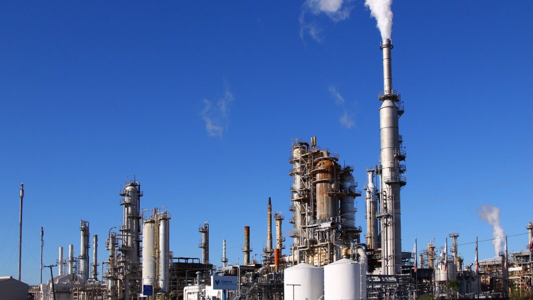 Producer Prices Jumped 1.3% in September, the Biggest Monthly Rise Since March 2022 Refinery towers, tanks and a smokestack releasing white steam under a clear blue sky